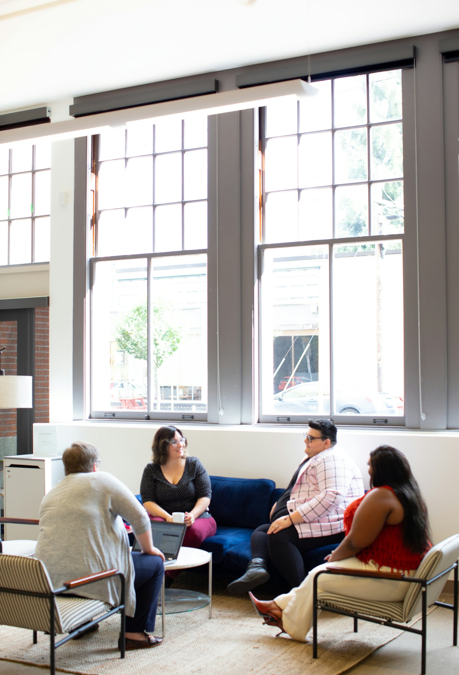 A small group talking together in a bright room