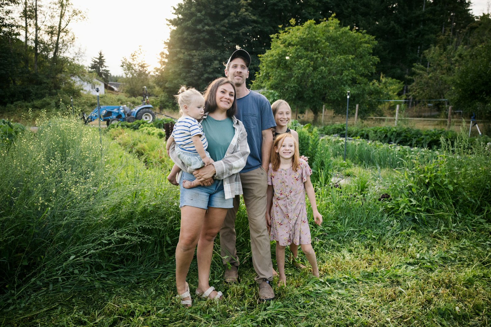 A family standing together in a green field